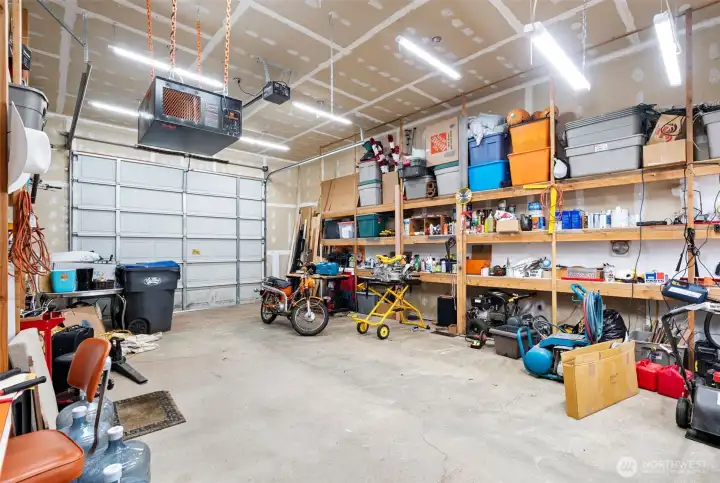 33' x 20' RV garage lined with storage shelving and its own washer and dryer