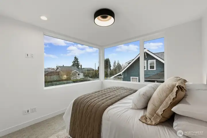 Primary bedroom with large corner windows.