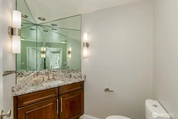The main floor powder room has an infinity mirror.