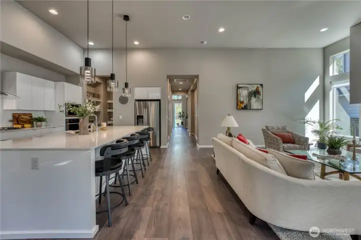 Seamless lines lines with high ceilings, this open floor plan lives very well.