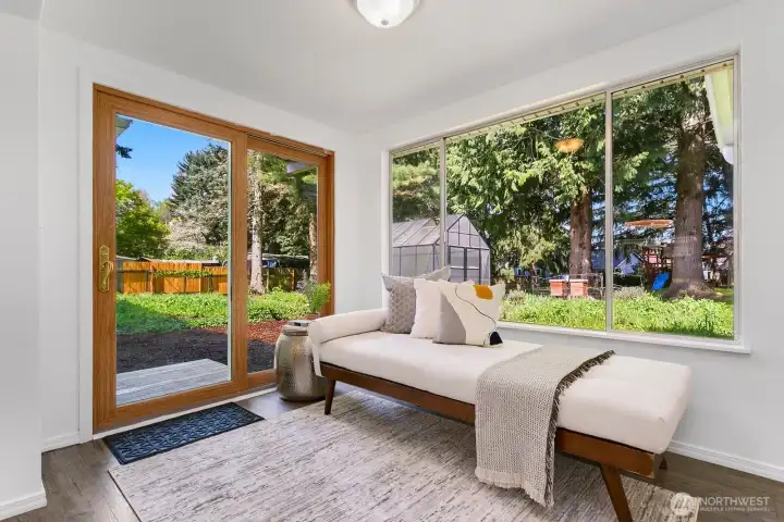 Sunroom between kitchen and bonus room with sliding glass doors to outside