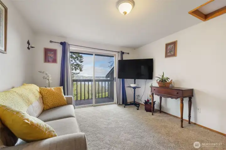 Upper level bedroom with private balcony and views of the Sound.