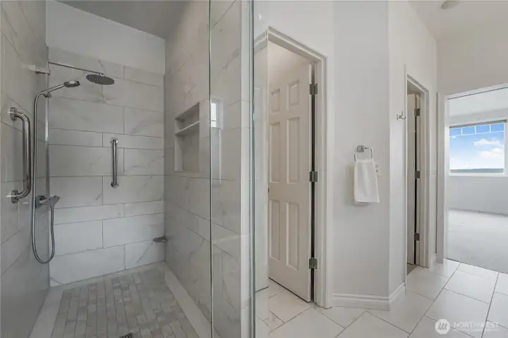 Updated & spacious primary bath walk in shower is light & bright!