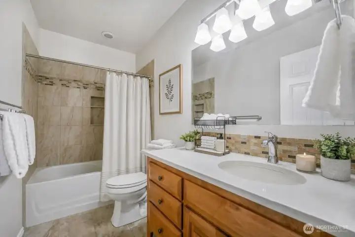 Guest Bath downstairs offers a tub & lots of counterspace & cabinet storage!