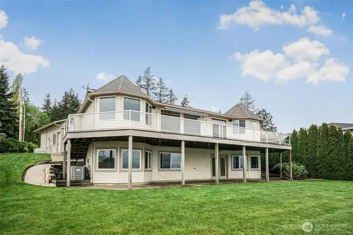 This beautiful custom home has a sunny backyard and terraces for gardening!