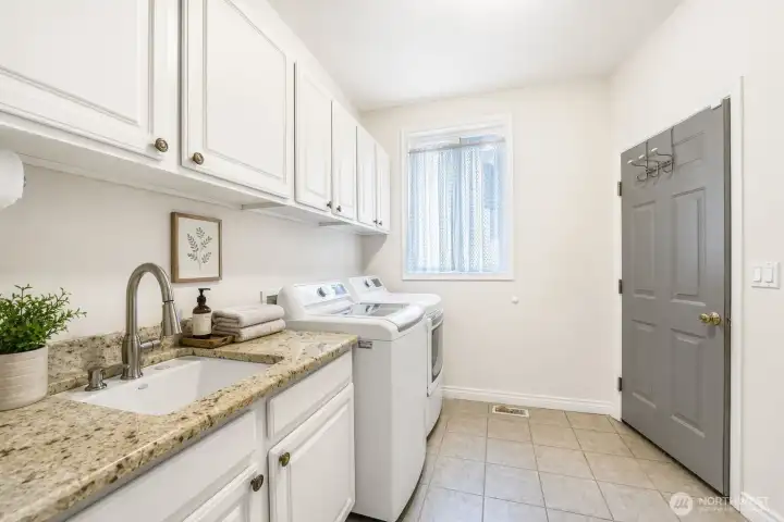 Spacious light & bright mud room leads out to the garage.