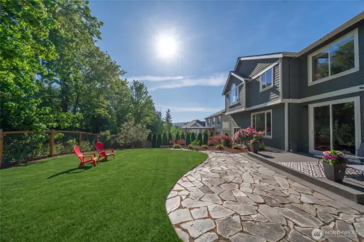 Nestled against a private greenbelt on a beautifully maintained 7,000+ sqft lot