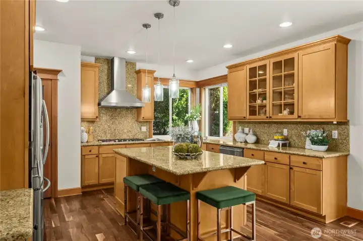 Warm custom cabinetry and stainless steel appliances