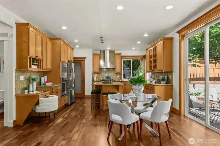 The breakfast nook dining area and seamless access to the outdoor patio create an inviting indoor-outdoor lifestyle