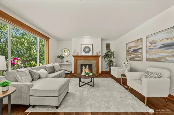 Large windows overlook the private backyard, filling the room with natural light and creating a seamless indoor-outdoor connection