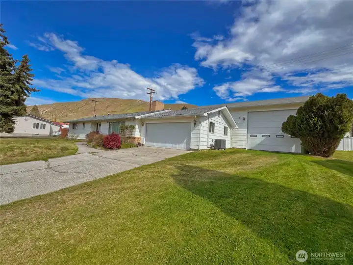 Generous driveway space provides ample RV parking and room for recreational toys, complemented by a 14-foot-high door for easy access to 1,116 sf of finished shop space and 1,080 sf ADU.