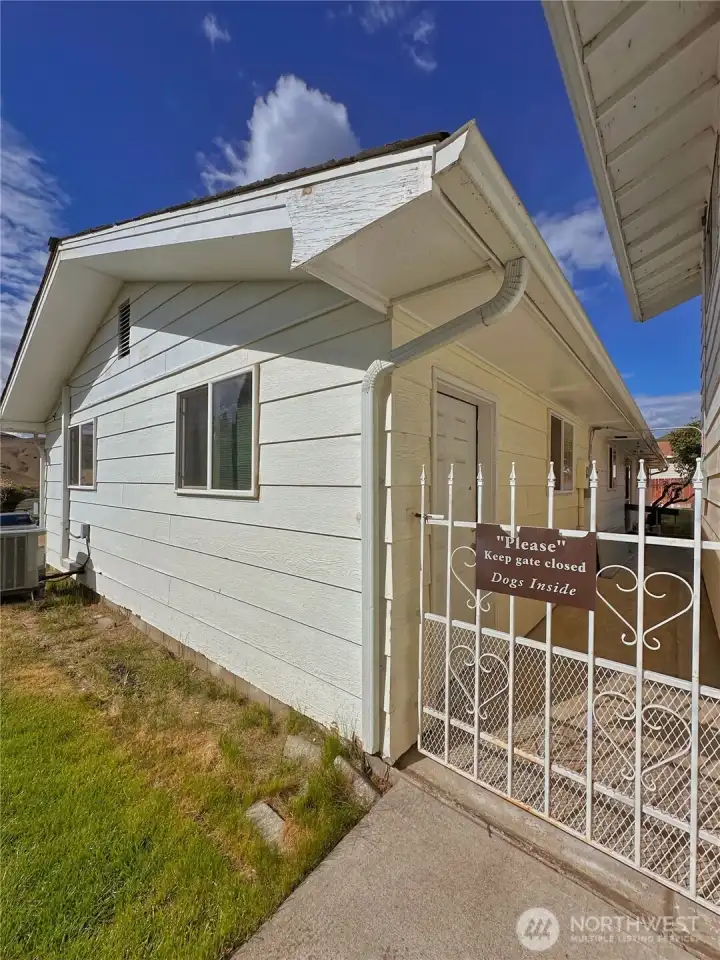 Gated breezeway access to attached garage, backyard and ADU unit.