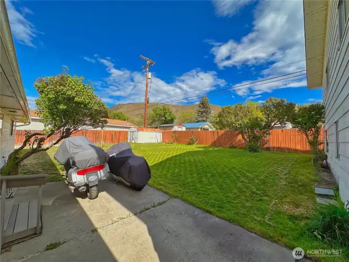 Patio space with fenced back yard view (sorry, motorcycles not included).