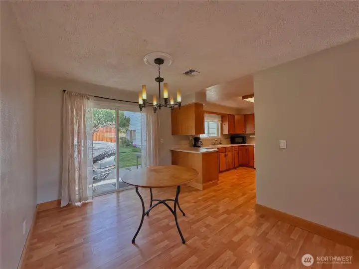 Easy indoor-outdoor flow from dining room slider to a fenced backyard and patio is perfect for gatherings or quiet evenings at home.