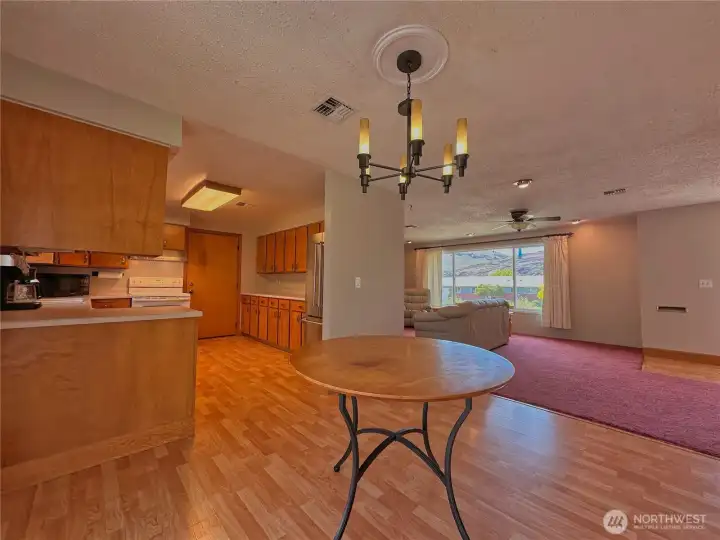 Easy-care laminate flooring flows seamlessly through the kitchen, dining area, and main entry.