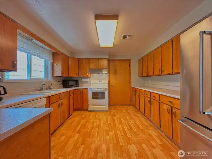 Kitchen offers abundant cabinetry for storage along with generous counter space for meal prep and everyday functionality.