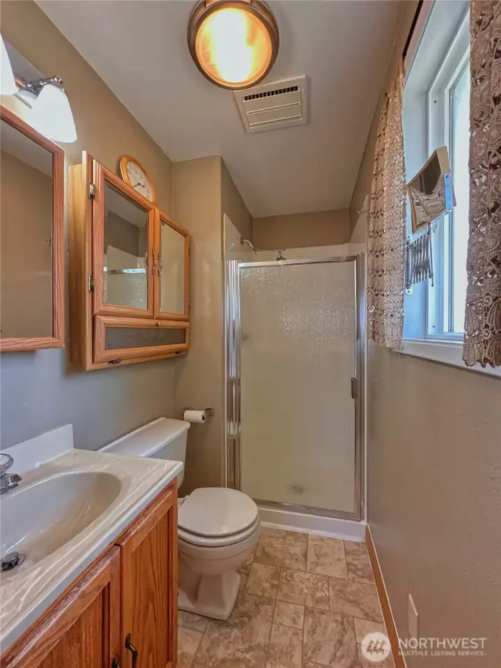 Three-quarter bath conveniently located off the primary bedroom.