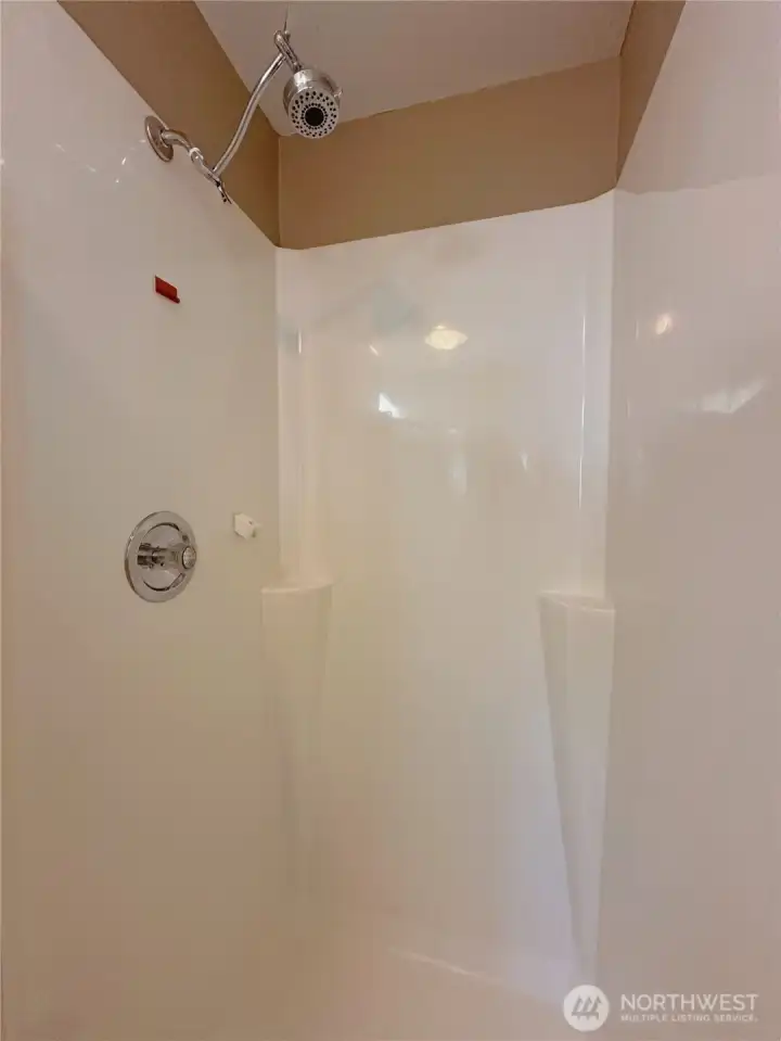 Updated low-maintenance vinyl shower surround offering easy upkeep and a clean, modern look.