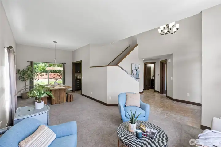 The living room and dining room seamlessly flow together and allow for easy conversation between rooms. This open design creates a welcoming and sociable atmosphere, perfect for both everyday living and entertaining.