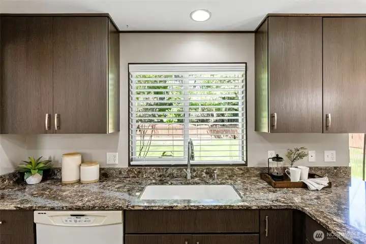 The kitchen has lovely views to the level back yard, which is completely fenced in, making it pet-friendly.