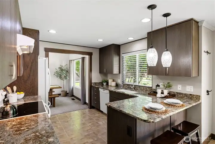 There is plenty of cabinet storage and counter space in this beautiful kitchen. The opening to the dining room has been widened, allowing for the spaces to coexist even better.