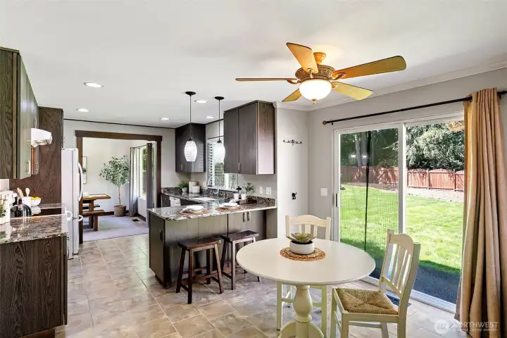 A sliding door to the back yard patio is directly off the nook area. A ceiling fan is perfect for keeping air flowing on warmer days/evenings.
