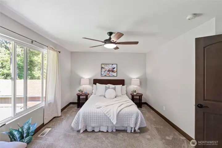 The primary bedroom is large enough for a king-size bedroom set and has lovely views to the beautiful back yard and green belt.