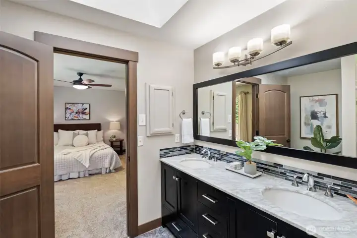 A refreshed vanity, lighting, flooring, and a nice skylight that brings the outdoors in is a part of the primary bathroom.