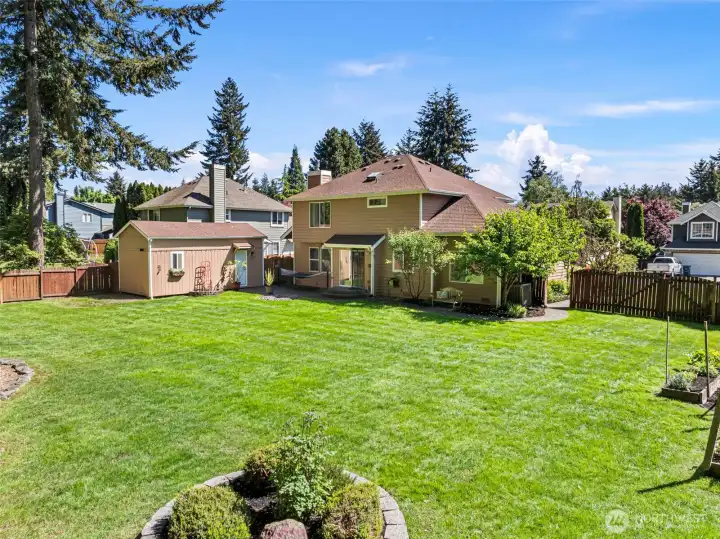 This level, fully-fenced backyard features an Asian pear fruit tree and a ready-to-go garden space. The yard also receives ample sunshine on beautiful PNW days.