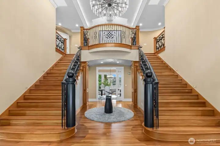 Dazzling foyer with dual staircases, artisan walnut inlays, & magnificent Restoration Hardware chandelier. Dazzling foyer with dual staircases, artisan walnut inlays, & magnificent Restoration Hardware chandelier.