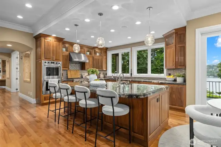 A massive center island with seating bar completes the open, social layout. A massive center island with seating bar completes the open, social layout.