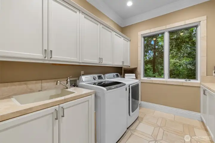 Laundry day is a breeze with this main floor utility room plus two more laundry sets upstairs. Laundry day is a breeze with this main floor utility room plus two more laundry sets upstairs.