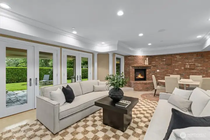 Lower level rec room with cozy brick fireplace & more French doors opening to the patio. Lower level rec room with cozy brick fireplace & more French doors opening to the patio.