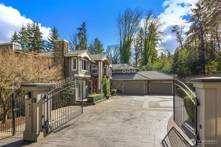 A gated entry opens to the recently resealed driveway. A gated entry opens to the recently resealed driveway.