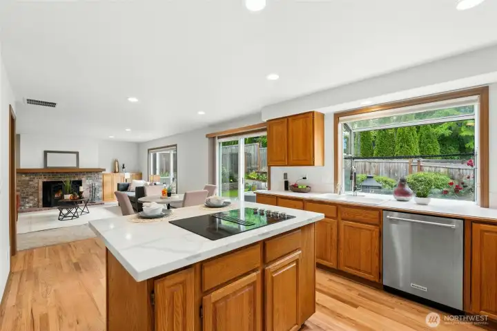 Kitchen opens to family room with fireplace and slider to the patio and backyard.
