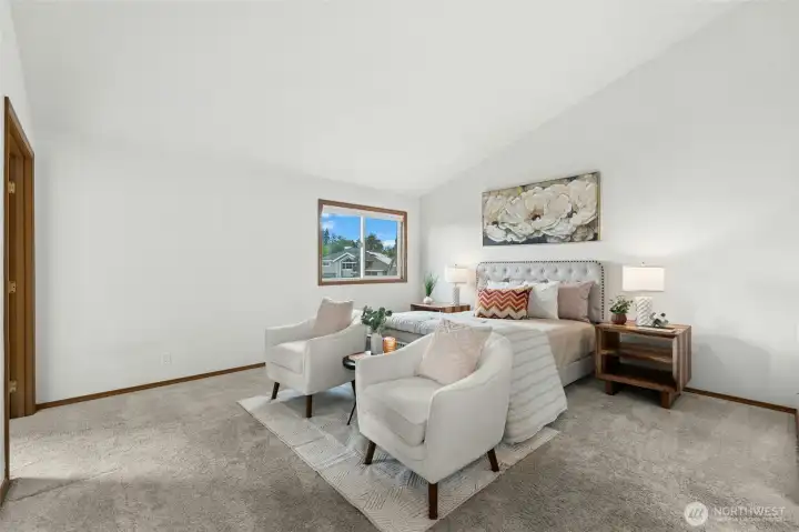 Primary bedroom with vaulted ceiling has room for your king sized bed plus a sitting area.