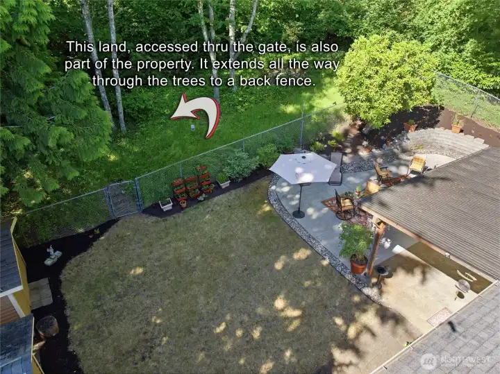 Backyard access through private gate to access the rest of the 18,540 sf lot.