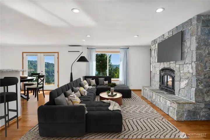 Living room view: a stunning picture-window panorama of Hood Canal and the peninsula—your daily backdrop for sunrise coffee and golden-hour sunsets.
