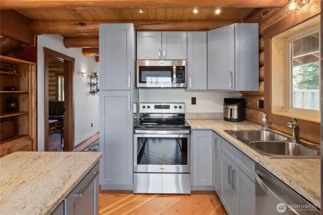 Timeless color on the cabinets that pairs nicely with the stainless steel and black appliances, that all stay with the home.