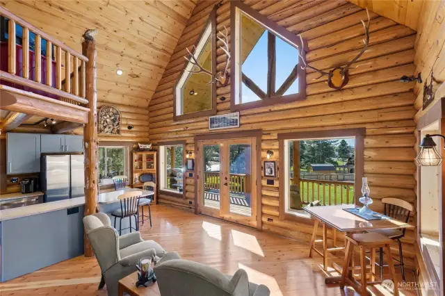 Vaulted ceilings and a wall of windows allowing natural light to fill the living space.