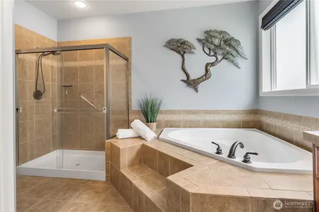 Indulge in spa-like luxury in this beautifully appointed primary bathroom, featuring a large soaking tub.