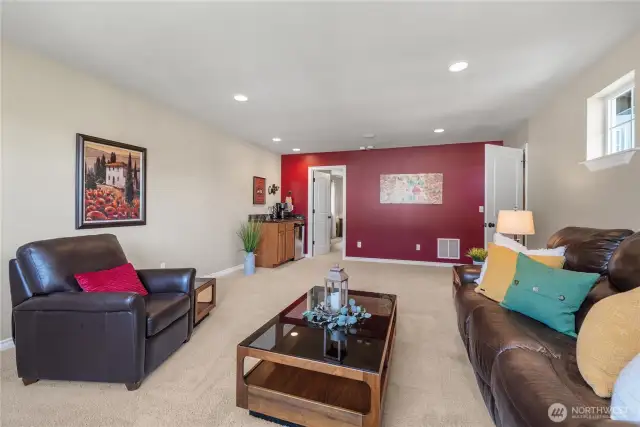 Upstairs, you will find this vibrant and spacious living area that with the kitchenette, offers the perfect setting for relaxing and entertaining.