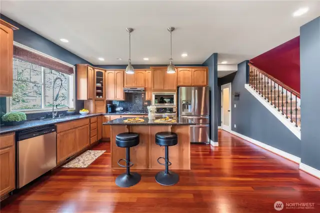 This stunning kitchen features warm wood cabinetry, sleek granite countertops, and stainless steel appliances, creating a perfect blend of style and functionality.