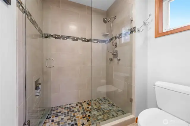 The bathroom in the primary bedroom is tastefully updated with a double sink vanity, large soaking tub, and a wonderfully relaxing shower.