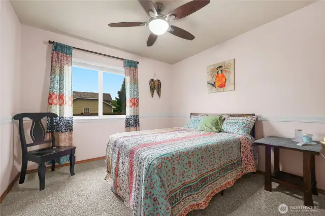 Bedroom #2 on main floor with new carpet and ceiling fan.
