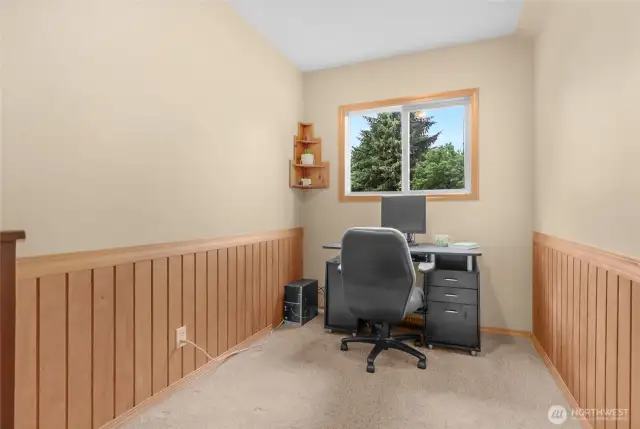 Hidden just above the garage and off the bonus room area is this wonderful office/den space with nice wood wainscoting.