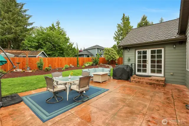 The large stamped concrete patio in the backyard is the perfect spot to entertain guests, and the tasteful landscaping makes it all the more pleasant.