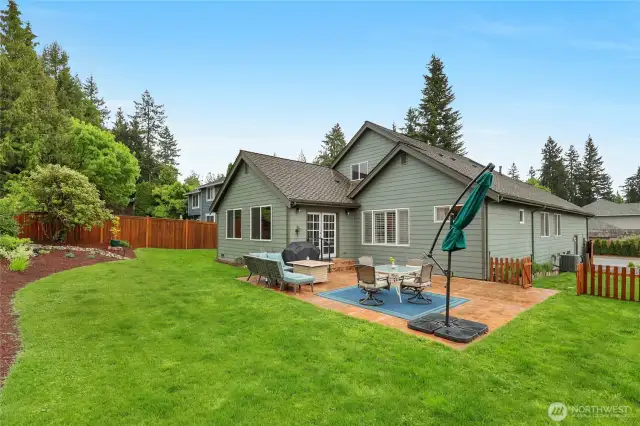 The large stamped concrete patio in the backyard is the perfect spot to entertain guests, and the tasteful landscaping makes it all the more pleasant.