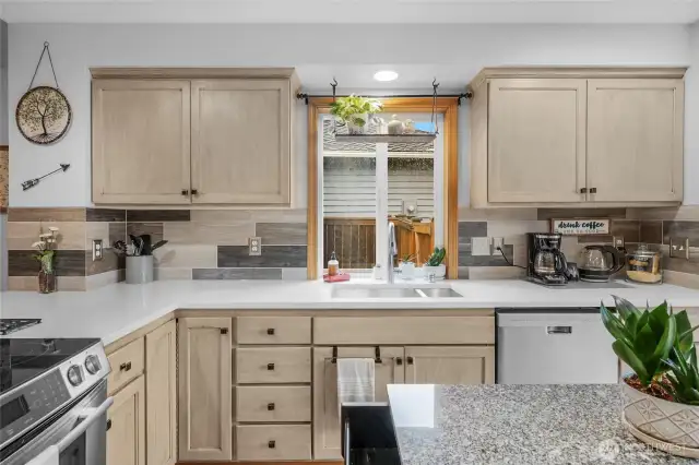 This kitchen's spacious design allows plenty of room for food preparation, plus there's no lack of storage. The large countertop makes this an excellent location for doing so. The ample natural light makes the area bright.  Hardwood floors lead out to large dining room area and all appliances included!