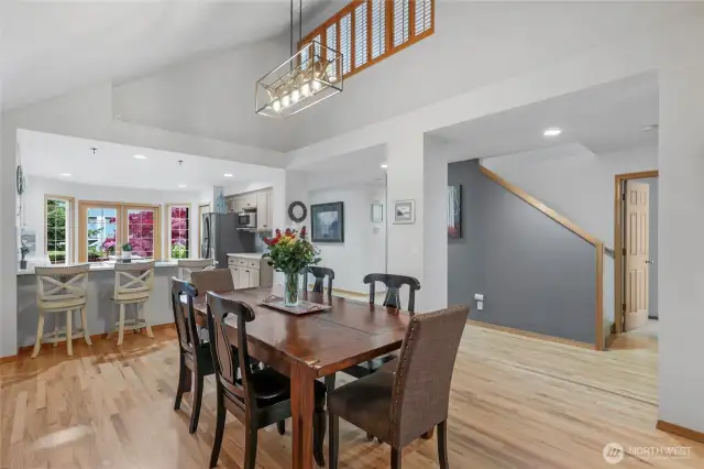 Large dining area just off kitchen includes vaulted ceilings and hardwood floors.